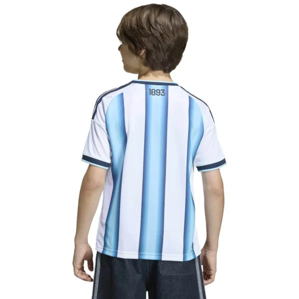 C4-1168652-636Wx636H Argentina 3-Star Home Jersey tailored in youth and kids' sizes. This classic kit features the iconic light blue and white stripes accented with gold branding, the official AFA crest, and three stars celebrating their historic World Cup victories.